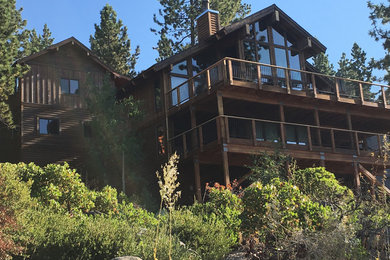 Large rustic brown three-story wood exterior home idea in Sacramento
