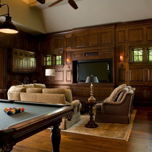 Example of a large classic open concept home theater design in Charleston with brown walls and a media wall