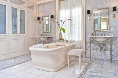 Design ideas for a traditional bathroom in DC Metro with a freestanding tub and a console sink.