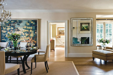 This is an example of a large contemporary dining room in London with beige walls and medium hardwood floors.