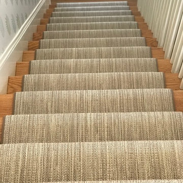Textured Stair Runner Against Floral Wallpaper