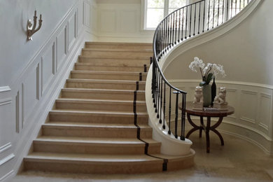 Staircase - huge tile curved staircase idea in Orange County with tile risers