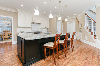 Large minimalist light wood floor kitchen photo in Atlanta with shaker cabinets, quartz countertops, ceramic backsplash, stainless steel appliances and an island