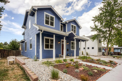 Large elegant blue three-story wood exterior home photo in Denver with a shingle roof
