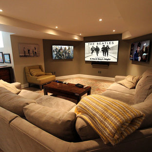 Medium sized traditional open plan home cinema in Toronto with beige walls, laminate floors, a wall mounted tv and brown floors.