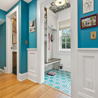 Design ideas for a mid-sized eclectic mudroom in Minneapolis with grey walls, green floor and a white front door.