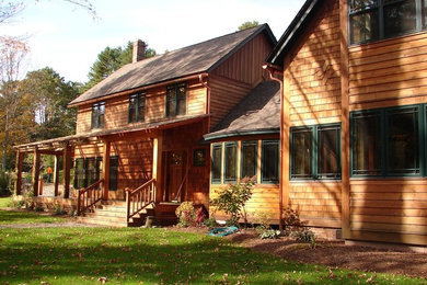 Design ideas for an arts and crafts two-storey exterior in Boston with wood siding.
