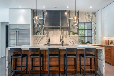 Inspiration for a kitchen in Other with an undermount sink, flat-panel cabinets, medium wood cabinets, marble benchtops, grey splashback, marble splashback, stainless steel appliances, concrete floors, with island, grey floor and grey benchtop.