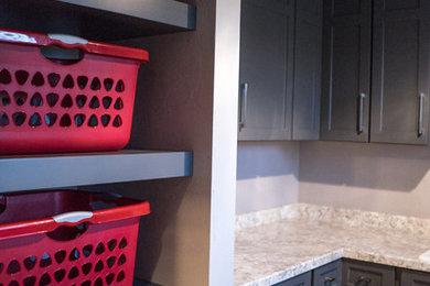 This is an example of a mid-sized transitional u-shaped utility room in Other with shaker cabinets and grey cabinets.