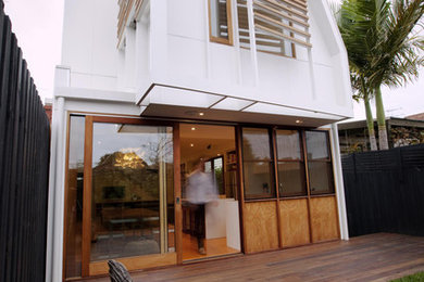 Inspiration for a contemporary one-storey white exterior in Melbourne with wood siding.