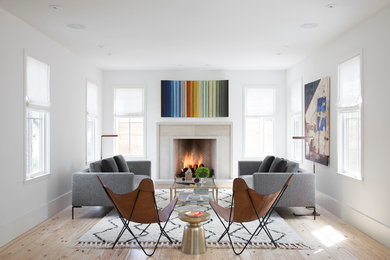 Example of a danish formal and open concept light wood floor living room design in Austin with no tv, white walls, a standard fireplace and a stone fireplace