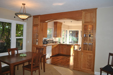 Example of a mid-sized arts and crafts dark wood floor kitchen design in Boise with shaker cabinets, medium tone wood cabinets, a peninsula, an undermount sink, granite countertops, ceramic backsplash and white appliances