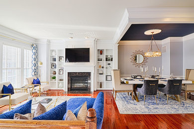 Inspiration for a large transitional formal and open concept dark wood floor and brown floor living room remodel in DC Metro with a wall-mounted tv, gray walls, a standard fireplace and a stone fireplace