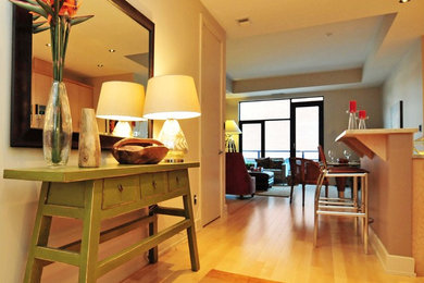 Inspiration for a small contemporary light wood floor entry hall remodel in Toronto with beige walls