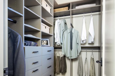 Small contemporary gender-neutral walk-in wardrobe in San Francisco with open cabinets, grey cabinets, dark hardwood floors and brown floor.