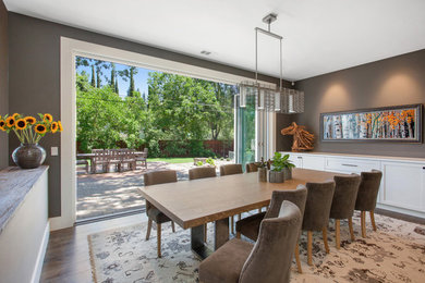 Elegant dark wood floor dining room photo in San Francisco with brown walls