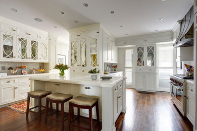 Inspiration for a large contemporary u-shaped brown floor and dark wood floor enclosed kitchen remodel in Chicago with an undermount sink, shaker cabinets, white cabinets, marble countertops, gray backsplash, subway tile backsplash, stainless steel appliances and an island