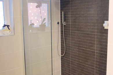 This is an example of a large modern family bathroom in Other with white cabinets, a built-in bath, a walk-in shower, grey tiles, white walls and ceramic flooring.