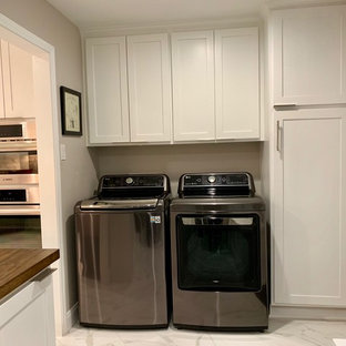 Design ideas for a small classic u-shaped utility room in Houston with shaker cabinets, white cabinets, wood worktops, grey walls, marble flooring, a side by side washer and dryer, white floors and brown worktops.