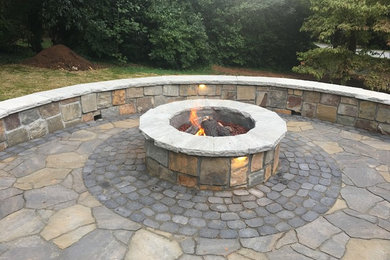 Inspiration for a mid-sized eclectic backyard patio in Other with a fire feature, concrete pavers and no cover.