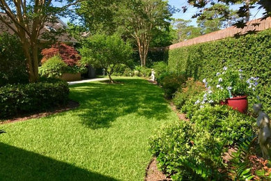 This is an example of a mid-sized traditional partial sun backyard concrete paver landscaping in Charleston for summer.