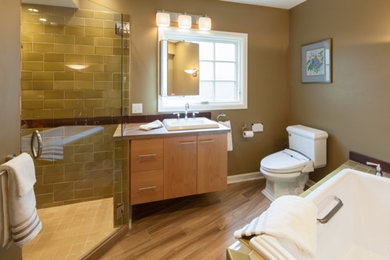 Example of a mid-sized southwest master multicolored tile and ceramic tile ceramic tile bathroom design in Portland with a drop-in sink, flat-panel cabinets, medium tone wood cabinets, tile countertops, a bidet and green walls