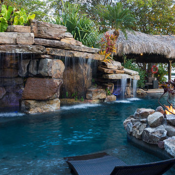 Custom Rock Waterfall Pool with Stone Grotto, Stream and Tiki Hut