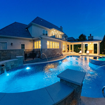 Naperville, IL freeform swimming pool with hot tub, large sunshelf, glass tile
