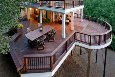 Photo of a large arts and crafts backyard deck in Atlanta with a container garden and a roof extension.