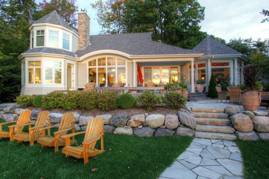 Inspiration for a large timeless beige two-story wood exterior home remodel in Toronto