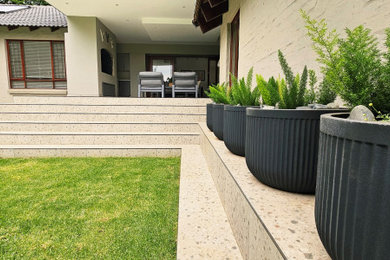 Photo of a large contemporary full sun backyard formal garden in Other.