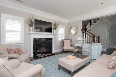 Living room - large coastal enclosed dark wood floor and brown floor living room idea in Charleston with gray walls, a standard fireplace, a tile fireplace and a wall-mounted tv