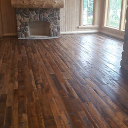 Reclaimed Mixed Hardwood Flooring by a Stone Fireplace - Hardwood Flooring