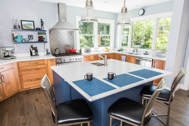 Inspiration for a large transitional u-shaped porcelain tile and gray floor kitchen remodel in Other with an undermount sink, shaker cabinets, medium tone wood cabinets, quartz countertops, stainless steel appliances and an island