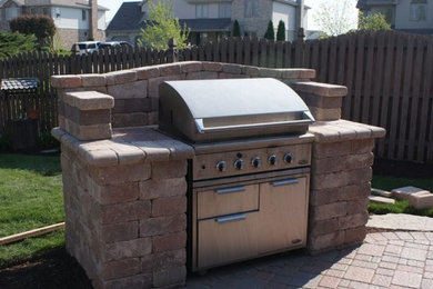 Patio kitchen - mid-sized southwestern backyard stone patio kitchen idea in Chicago with no cover