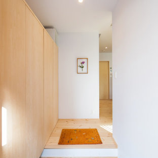 Inspiration for a scandinavian entryway in Other with a single front door and a medium wood front door.