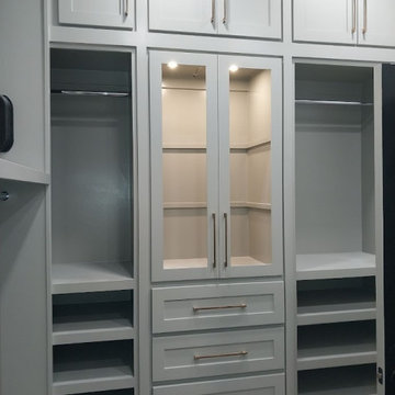 Custom Walk-In Closet with Glass-Front Cabinets & Pull-Down Storage