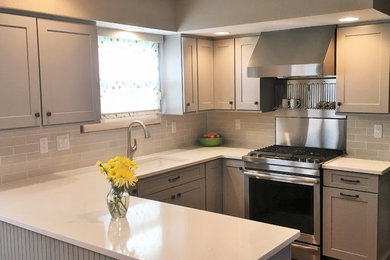 Transitional u-shaped dark wood floor and brown floor eat-in kitchen photo in Denver with shaker cabinets, a double-bowl sink, gray cabinets, concrete countertops, gray backsplash, subway tile backsplash, stainless steel appliances and no island