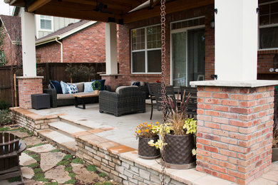 Small arts and crafts backyard concrete patio photo in Denver with a roof extension