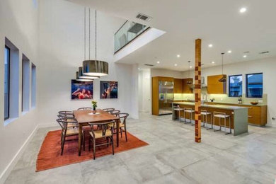 Inspiration for a large contemporary kitchen/dining combo in Los Angeles with porcelain floors and white walls.