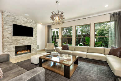 Family room - transitional beige floor family room idea with beige walls, a standard fireplace, a stone fireplace and a wall-mounted tv