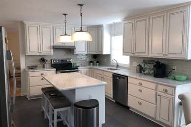 This is an example of a mid-sized traditional l-shaped eat-in kitchen in Baltimore with white cabinets, marble benchtops and subway tile splashback.