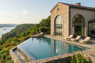 Inspiration for a large mediterranean beige two-story brick and shingle exterior home remodel in Other with a tile roof and a red roof