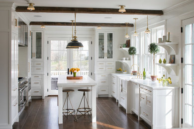 Design ideas for a country kitchen in New York with flat-panel cabinets, white cabinets, white splashback, dark hardwood floors and with island.