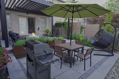 Medium sized contemporary back patio in Toronto.