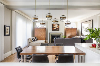 Mid-sized transitional open concept medium tone wood floor and brown floor family room photo in Calgary with gray walls, a standard fireplace and a stone fireplace