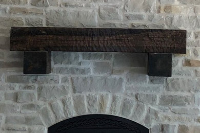 Mid-sized arts and crafts open concept game room photo in Other with multicolored walls, a standard fireplace and a stone fireplace