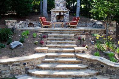Large trendy backyard stone patio photo in Atlanta with a fire pit and no cover
