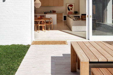 This is an example of a beach style patio in Sydney.