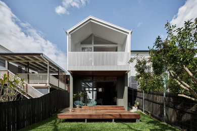 This is an example of a contemporary one-storey white house exterior in Brisbane with a gable roof.